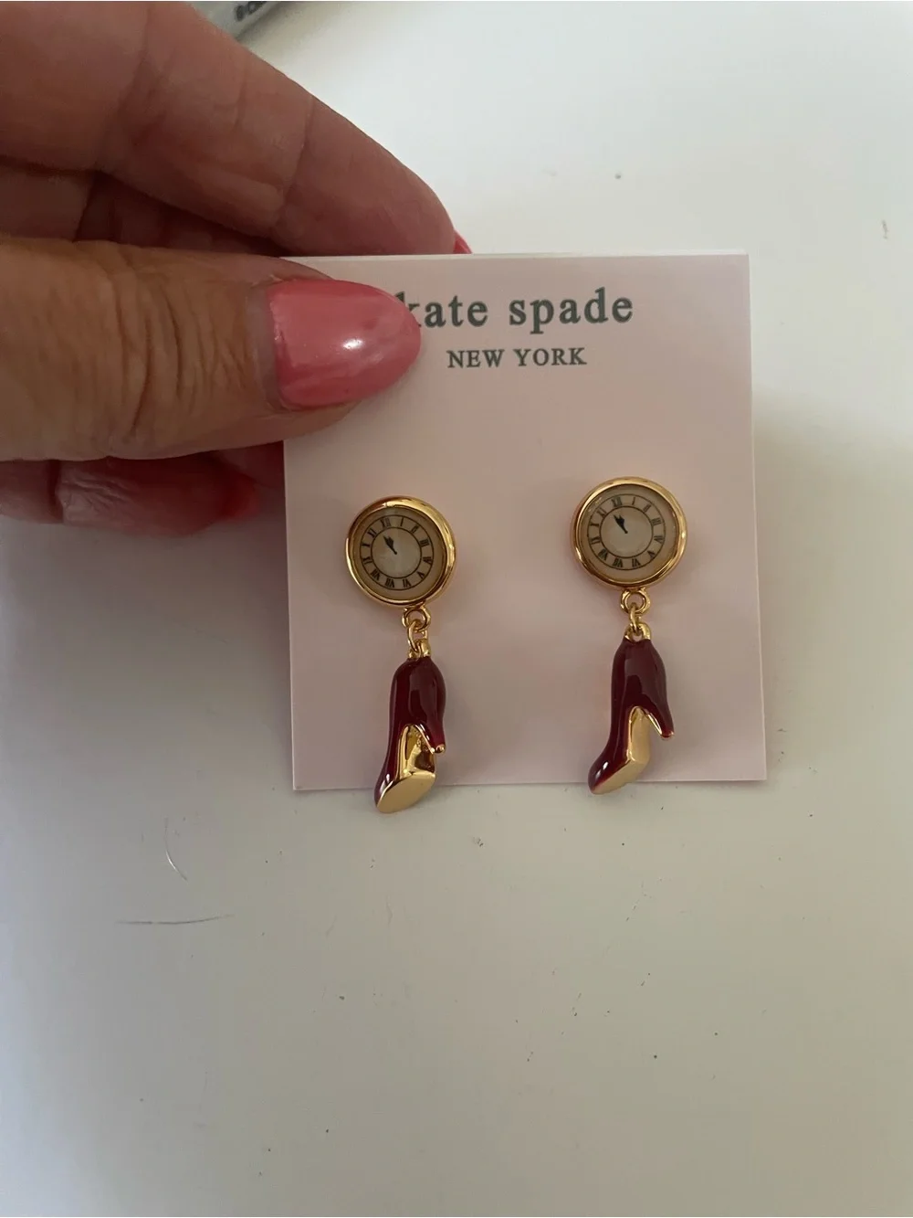 Devil wears Prada Kate Spade earrings red heels & clock